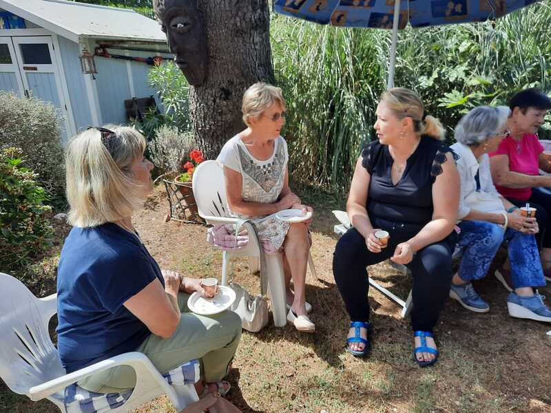 A group of women enjoying talking in a lovely garden in nice weather