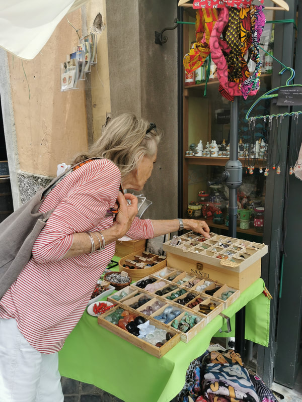 A lady looking at crystals. After all, she is in Nemi.